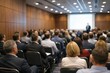 © Z - Rear view of a professional conference hall with a large audience attending a business presentation, visible presentation content on screen, modern corporate training or seminar environment.