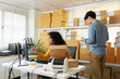 © SAT65 - Small Business owner, Businesswoman Inspects a shipping box while her colleague Manages stock shelves, organized inventory, checking the package box preparing to dispatch. E-commerce fulfillment.