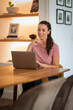 © gzorgz - Woma using her laptop computer and working from home