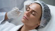 © Milos - A woman relaxes while receiving cosmetic injections, showcasing a natural approach to beauty and wellness in a modern clinical setting designed for aesthetic procedures.