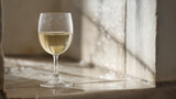 corretto. A clear glass of white wine on a stone ledge with condensation. bar promotions, beverage menus, designed for food & beverage menus and cafe branding, enhances appetite appeal.