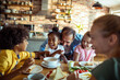 © Davor - Happy family with children eating breakfast at home kitchen