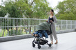 © leungchopan - Mother push stroller outdoor on street