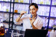 © Petro - Female perfumer crating perfumes at her laboratory