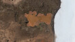 © AmazingAerialAgency - Aerial view of a rusty-red pond nestled amidst the rugged terrain, contrasting sharply with the stark white shoreline, Selfoss, Iceland.