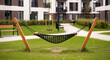 © PRANGOBINDA - Black Hammock in a Grassy Courtyard with Apartment Buildings
