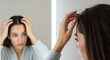 © holistock - A woman touching her hair, appearing thoughtful or concerned.