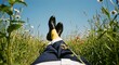 © Helen - Man relaxing in field with blue suit, yellow socks and black shoes. Spring break weekend holiday. Summer outdoors with copy space.