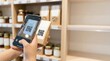 © Running opossum - person scanning product qr code with smartphone in organic grocery store aisle