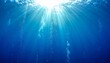© Argiduna - Rayos de sol atraviesan el agua azul profunda, iluminando burbujas que ascienden hacia la superficie en un paisaje submarino sereno y radiante.