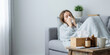 © PureStock - Home woman winter disease health with korean season unhealthy ache allergy asia autumn blanket blowing nose on sofa feeling sick and lonely