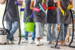 © Pixel-Shot - Team of janitors with cleaning supplies in office after New Year party