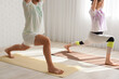 © Pixel-Shot - Sporty young couple practicing yoga together in light room, closeup