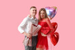 © Pixel-Shot - Lovely couple with bouquet of flowers and heart-shaped balloons on pink background. Valentine's Day celebration