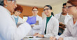 © MagicDavid25/peopleimages.com - Science teacher, students and learning with lesson for education or experiment together in class. Group, learners and listening with mentor for scientific results, studying or asessment in school lab