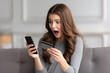 © Photoenthusiast82 - Young woman at home tries payment on smartphone with credit card sees alert for low funds and has credit card blocked