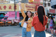 © Phimwilai - Young asian women friends capturing travel memories on street