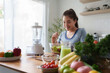 © crizzystudio - Young woman enjoying fresh healthy salad in kitchen
