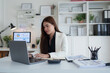© crizzystudio - Businesswoman analyzing financial data on modern office laptop