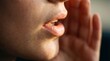 © Javed - Intimate close up of a person's mouth mid whisper with lips slightly parted and hand cupped near the speaker conveying secrets gossip and confidential communication in a soft