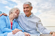 © BuyoutReese07/peopleimages.com - Love, elderly man or woman at lake with hug, retirement or bonding together on outdoor vacation. Holiday, portrait or old couple with embrace, weekend break or healthy relationship in Australia.