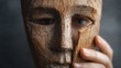 © Алексей Иванченко - Person holds wooden mask revealing face. Concept of identity change, inner self, and authentic expression. Revealing truth, overcoming deception, or starting anew