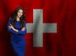 © millaf (Nemchinova) - Pretty young woman in blue dress smiling against flag of Switzerland background