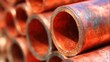 © tashechka - Copper pipes stacked in a construction site during daylight hours