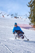© Alex - A wheelchair user skis down a mountain