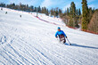 © Alex - Adaptive winter sports for people with disabilities - a man skiing down a mountain