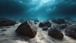 © Thares2020 - Sunlight beams penetrate clear blue ocean waters illuminating scattered rocks on the sandy seabed