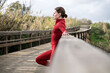 © Rob Wilkinson - sporty woman runner resting leaning on a railing on a boardwalk after exercise
