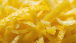© AuraArt - Close-up of vibrant yellow zesty lemon peels.