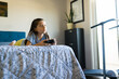 © AntonioDiaz - Cute girl concentrating on playing video game with controller on bed, enjoying leisure time at home