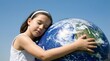 © David Zarzosa - A young girl embracing the earth globe as a symbol of environmental care and global sustainability.