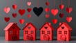 © Danish - Charming red paper craft houses sit beneath strings of hanging valentine hearts against a muted gray background creating a festive scene