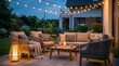 © olga_demina - Modern garden patio furniture illuminated by string lights and a candle, creating a comfortable ambiance for evening relaxation and entertaining in a home's backyard