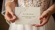 © pasar - Woman holding wedding invitation card closeup.