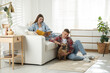 © New Africa - Couple with cute dog relaxing at home