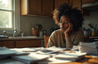 © Viktor - Overwhelmed single mother sits at kitchen table with stacks of bills, notices. She looks stressed by financial hardship, debt, bankruptcy. Facing family financial crisis, exhaustion, struggle.