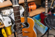 © Tosh Lubek - Acoustic guitars stored in storage unit among household items