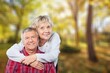 © BillionPhotos.com - Joyful old couple embracing posing in a natural setting.
