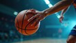 © Maryna - Close up of basketball player hand holding orange ball on court. Dynamic lighting. Blurred background shows audience and stadium lights. Focus on ball and hand.