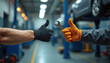 © Maryna - Two gloved hands give thumbs up signal holding metal wrench in car repair garage. Technicians approve auto service quality, teamwork spirit, safe car maintenance.
