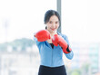 © Bangkok Click Studio - Asian young beautiful happy woman fit sporty healthy in sportswear boxing gloves learning practicing workout energy  exercise or learning self defense training in bright fitness gym wellness lifestyle