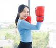 © Bangkok Click Studio - Asian young beautiful happy woman fit sporty healthy in sportswear boxing gloves learning practicing workout energy  exercise or learning self defense training in bright fitness gym wellness lifestyle