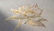 © THESUN - Elegant white and gold flower embroidery decoration. Beautiful handmade textile craft on light background showing delicate, gentle sophistication