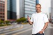 © BillionPhotos.com - young millennial man walking in city hold smart phone