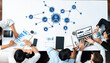 © InfiniteFlow - A group of business professionals collaborates on a CRM strategy, utilizing various technology tools, charts, and graphs to enhance teamwork and drive innovation. Amity