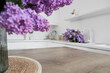 © Pixel-Shot - Sink with lilac flowers in light kitchen